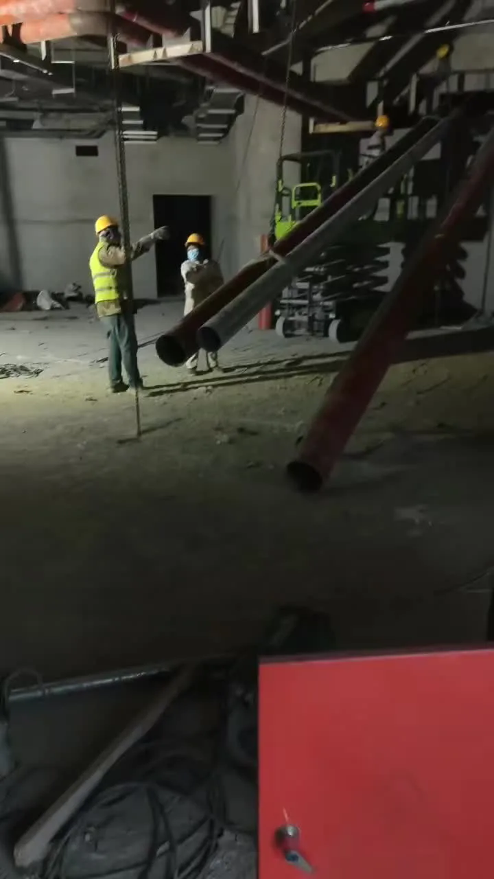 Workers in PPE handling materials in an industrial facility