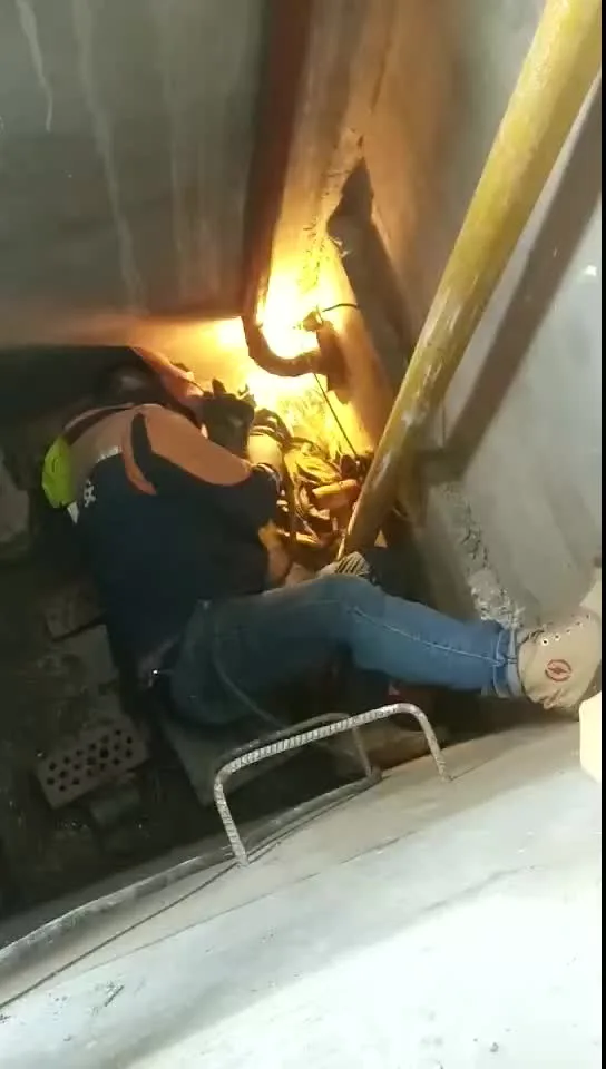 A welder working in a confined space with arc glow — real-world conditions where leather choice decides comfort and protection.